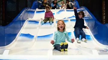 Children on a slide Hullabazoo children's indoor play area