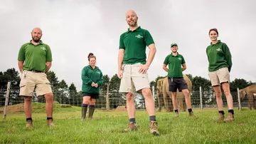 Elephant zookeepers at Whipsnade Zoo in front of elephant herd