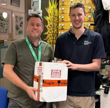 Alex Cliffe from Whipsnade Zoo hands over Boxer Pupfish eggs to The Bristol Zoo Project