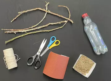 String, scissors, pin, sand paper, bird feed, plastic bottle, and sticks
