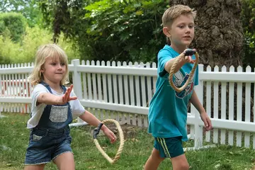 Two children throwing hoops