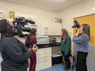 Shini guesses the animal from the X-ray with vet Harriet for Blue Peter