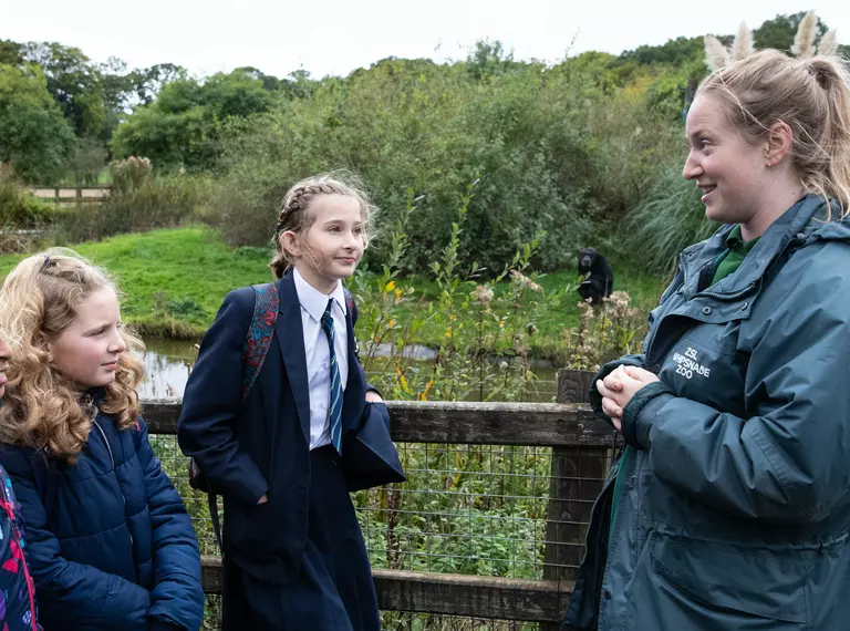A Whipsnade Zoo presenter with a four teenage school children