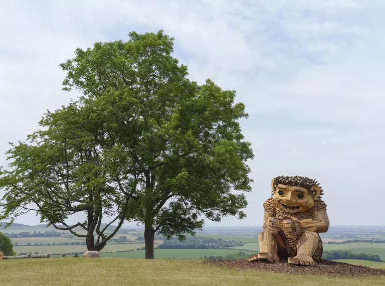 Image of a wooden troll that is part of the Trolls: A Field Study event at Whipsnade Zoo